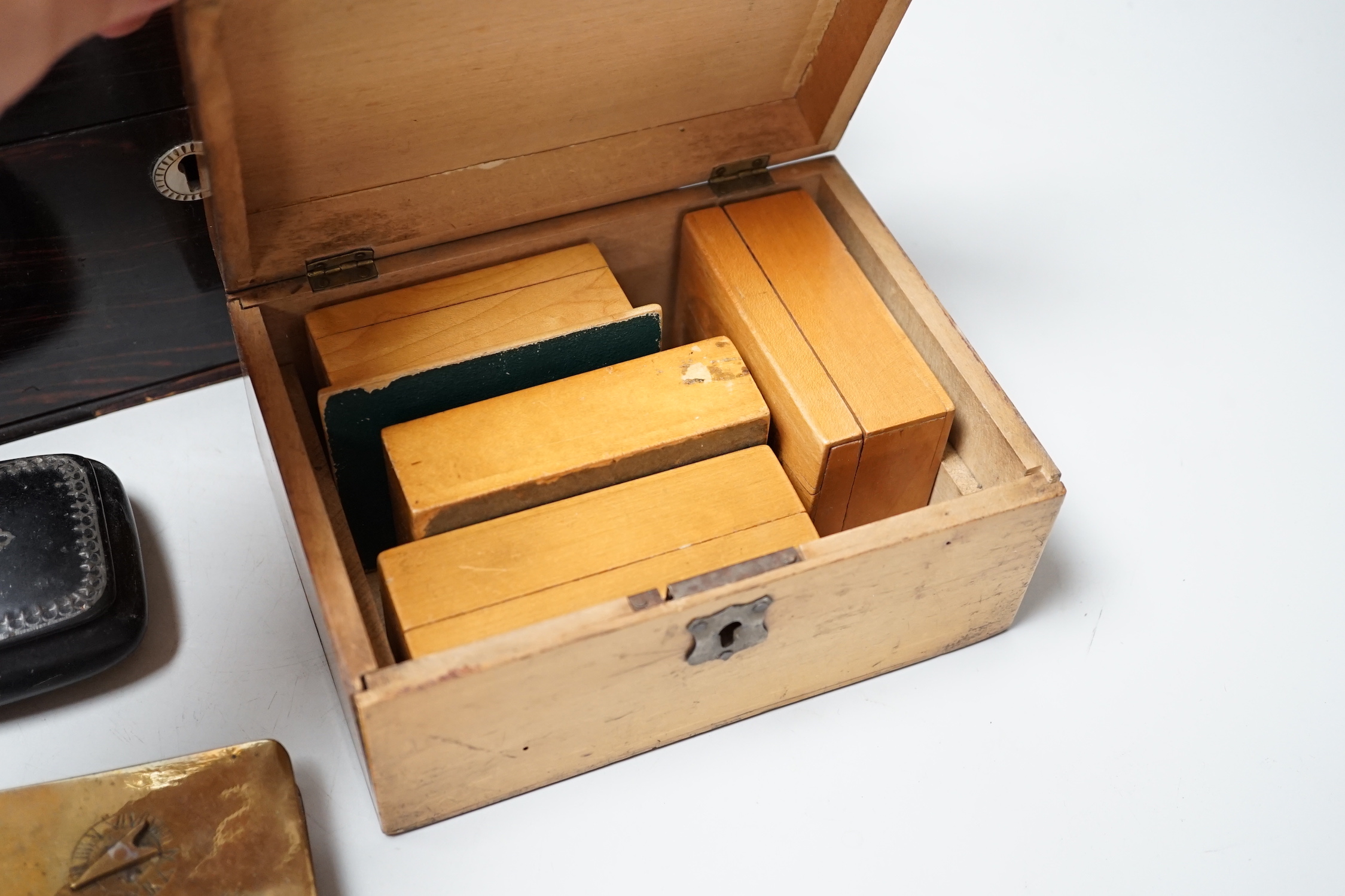 A Victorian Coromandel box containing a Victorian tortoiseshell mother-of-pearl inlaid card case, a Mauchline ware box and other boxes